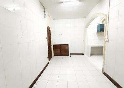 Simple kitchen with white tiles and wooden elements