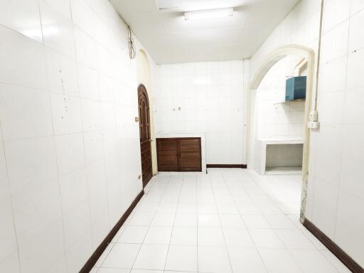 Simple kitchen with white tiles and wooden elements