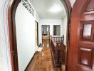 Spacious hallway with wooden flooring and decorative railing