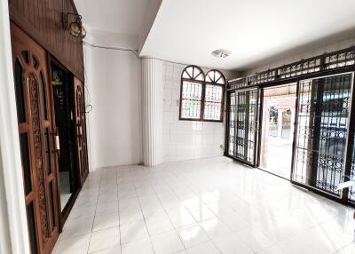 Bright and spacious living room with large windows and decorative metalwork