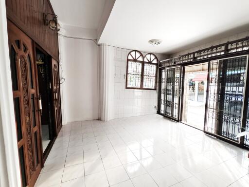 Bright and spacious living room with large windows and decorative metalwork