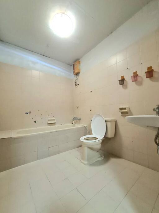 Spacious bathroom with bathtub and toilet