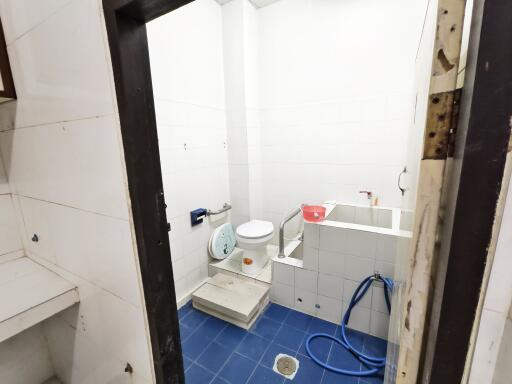 White tiled bathroom with blue floor tiles