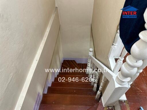 Staircase view with wooden steps and white balusters