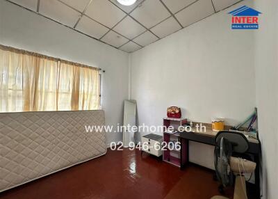 Bedroom with a window, a mattress, a desk, and a fan