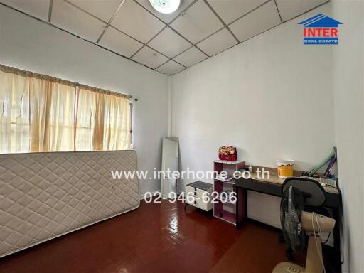 Bedroom with a window, a mattress, a desk, and a fan