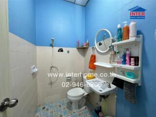 Bathroom with sink, shower, and shelves