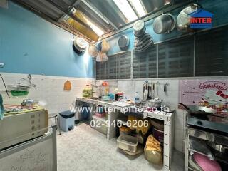 Spacious kitchen with cooking and storage areas