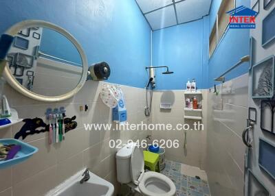 Bathroom with blue walls and white fixtures