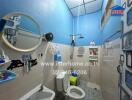 Bathroom with blue walls and white fixtures