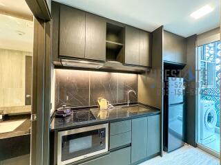 Modern kitchen with appliances and dark cabinets