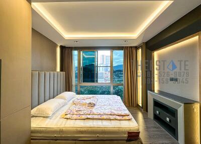 Modern bedroom with large windows and built-in lighting