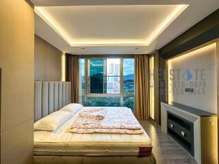 Modern bedroom with large windows and built-in lighting