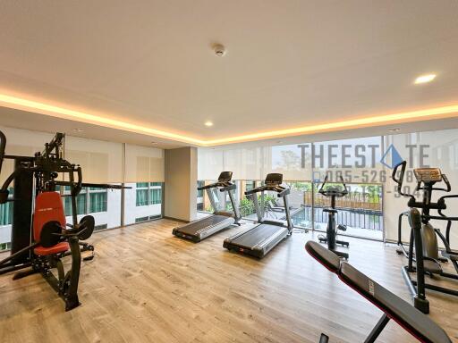 Modern gym with workout equipment and natural lighting