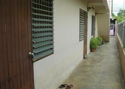 Exterior walkway with view of windows and door