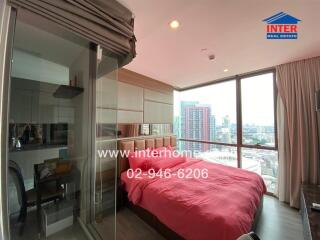 Modern bedroom with large window and city view