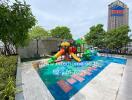 Outdoor playground with colorful play equipment and trees