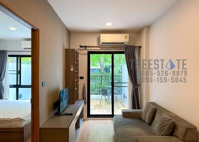 Modern living room with view of bedroom and balcony