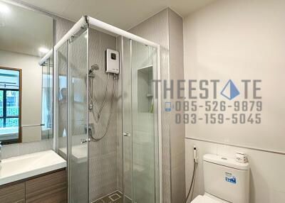 Modern bathroom with glass shower enclosure and toilet