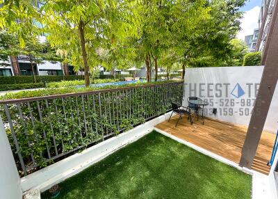 Outdoor patio area with greenery