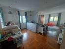 Spacious bedroom with wooden flooring and natural light