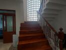 Staircase area with wooden steps and glass block wall