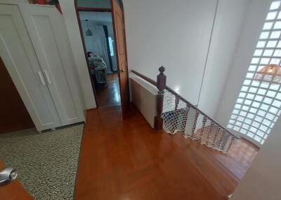 Hallway leading to a bedroom with stairs