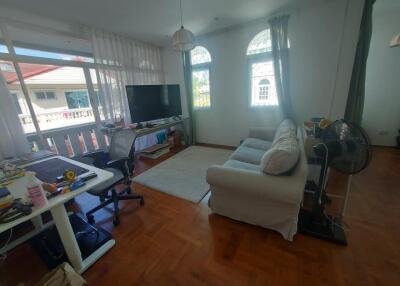 Well-lit living room with a working desk and seating area