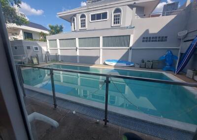 Outdoor swimming pool area with a view of a modern residential building