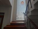 Staircase with large glass block window