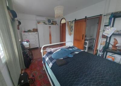 Spacious bedroom with bed, wardrobe, and ample storage