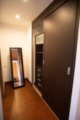 Modern hallway with large mirror and wooden flooring