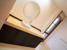 Modern bathroom with round mirror and sleek black vanity