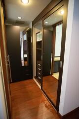 Modern bedroom with wooden flooring and mirrored closet