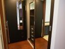 Modern bedroom with wooden flooring and mirrored closet