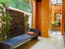 Outdoor seating area with bench, plants, and ceiling fan