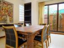 Elegant dining room with wooden table and modern chairs