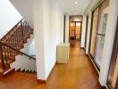 Interior hallway with staircase and windows