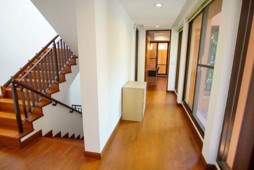 Interior hallway with staircase and windows