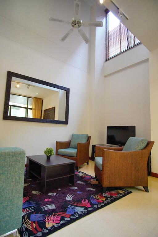 Living room with seating area and large mirror