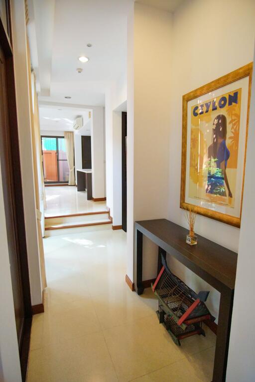 Hallway leading to living room with modern decor