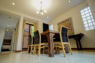 Spacious dining area with a wooden table and modern chairs