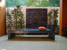 Outdoor seating area with bench and modern stone fountain