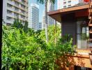 View from balcony with surrounding buildings and greenery