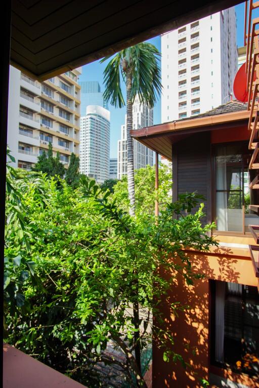 View from balcony with surrounding buildings and greenery