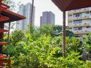 View from balcony with greenery and distant buildings