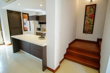 Modern kitchen with adjacent stairway