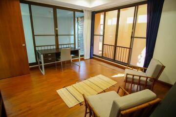 Spacious living area with large windows and natural lighting