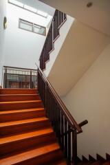 Interior staircase with wooden steps and modern railing