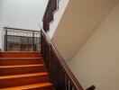 Interior staircase with wooden steps and modern railing